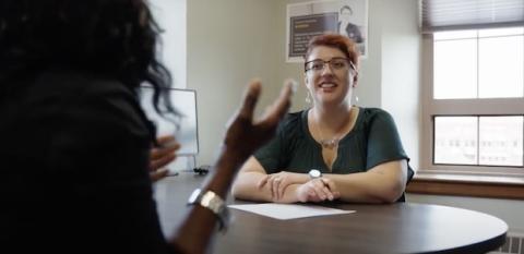 A housing counselor talks to a client.
