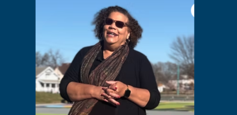 Margaret J. Wright against a blue sky.